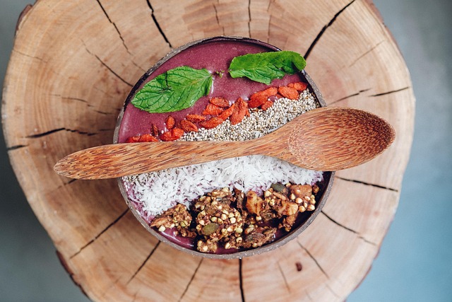 A person enjoying a healthy, colorful smoothie bowl in a bright setting, symbolizing vibrant wellness.